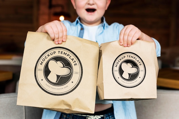 Close up boy holding food bags