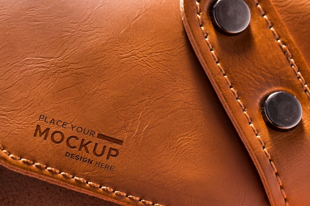 close-up of brown leather with strap and buttons