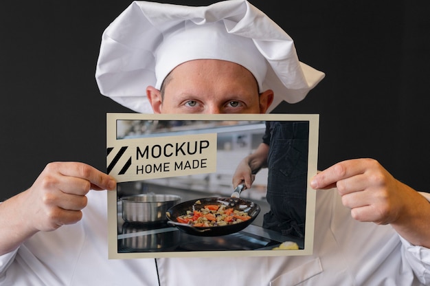 Close-up chef holding flyer