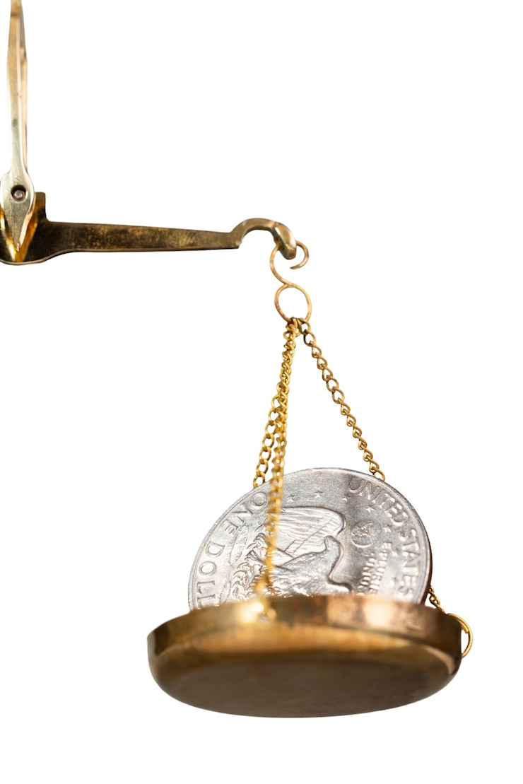 PSD close up on coins in scale isolated