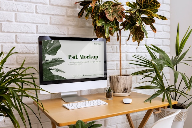 PSD close up on computer mockup surrounded by plants