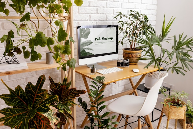 PSD close up on computer mockup surrounded by plants