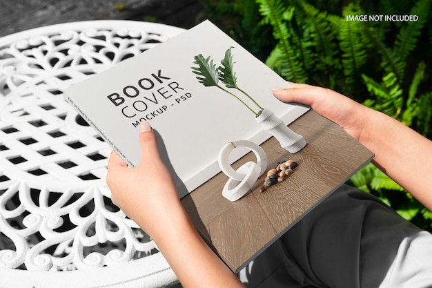 close up on hands holding a book mockup