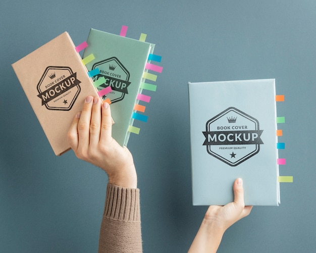 Close up hands holding books mockup