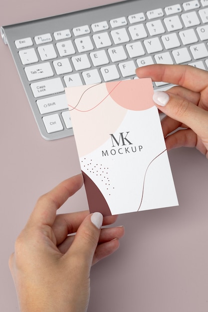 PSD close up hands holding business card mockup