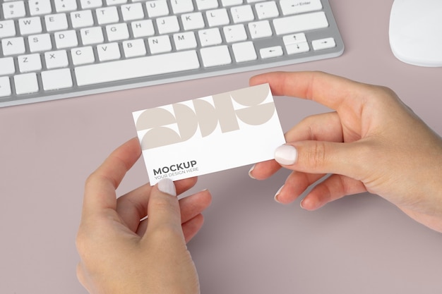 close up hands holding business card