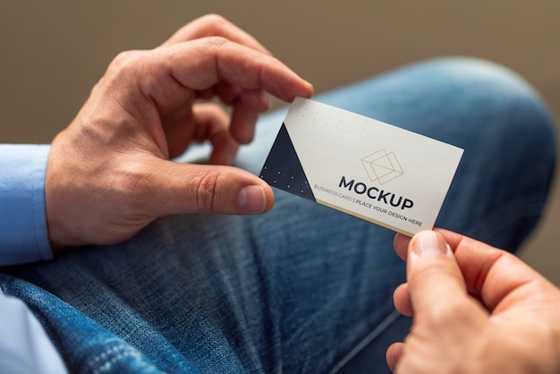 close-up man holding business card mock-up