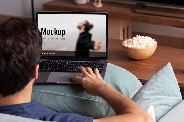 Close up man watching movie on laptop mockup