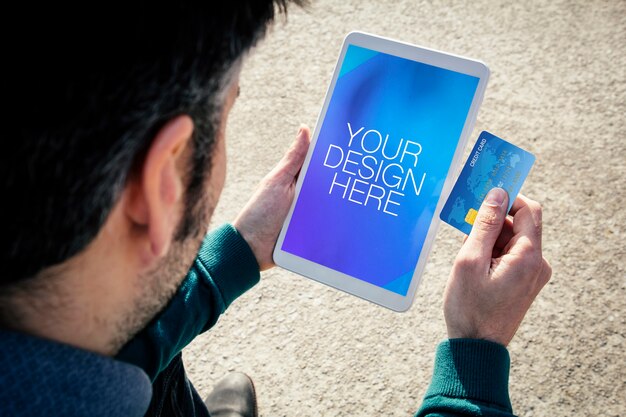 PSD close up on man with tablet and credit card mockup