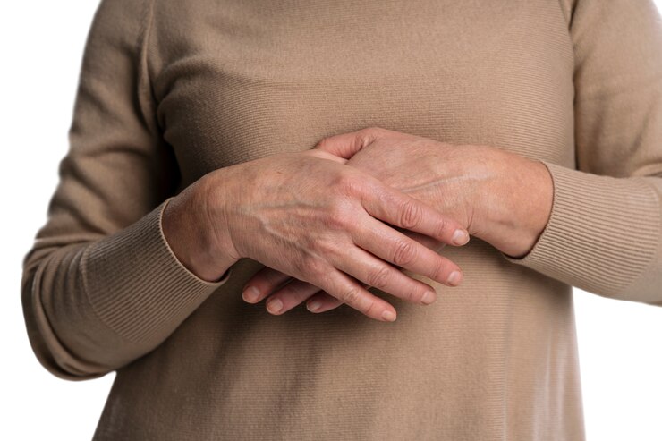 PSD close up on old woman holding hands near heart