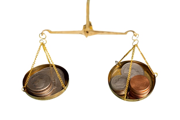 Close up on coins in scale isolated