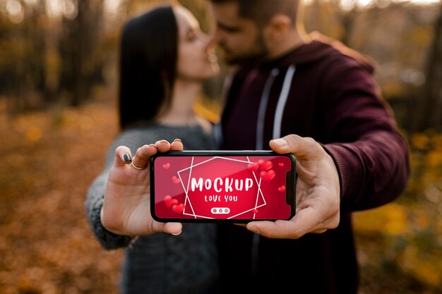 PSD close-up romantic couple holding phone