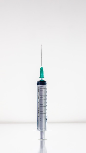 close-up shot of a syringe with a needle ready for injection
