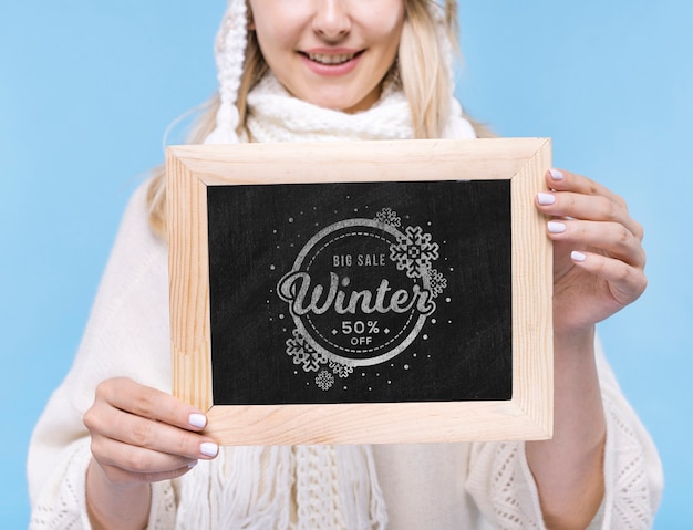 Close-up smiley girl holding mock-up sign