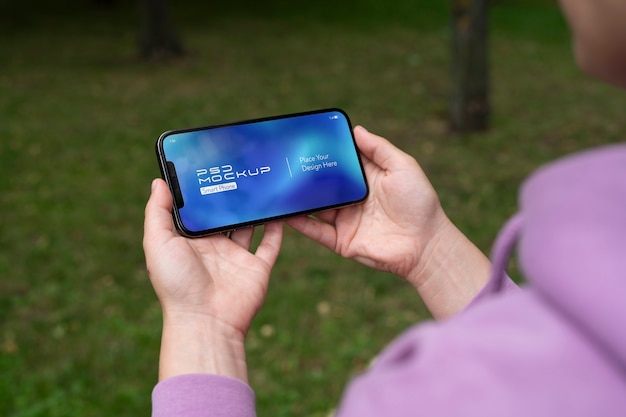 PSD close-up of touchscreen mock-up on smartphone held by person