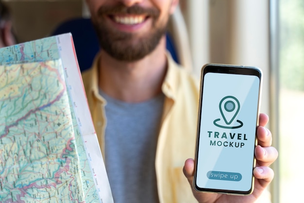 Close up on traveling young man holding smartphone mockup