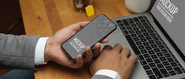 Close up view of businessman hand holding smartphone mockup