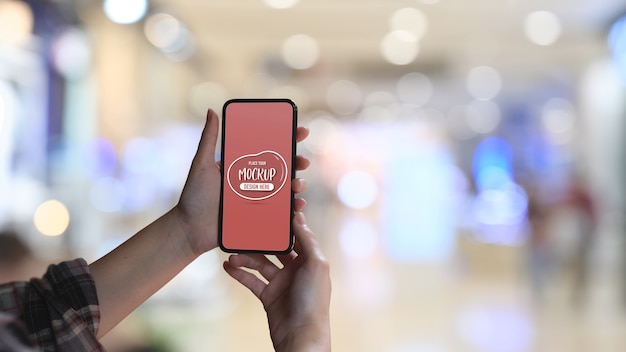 close up view of female hand holding mock up smartphone
