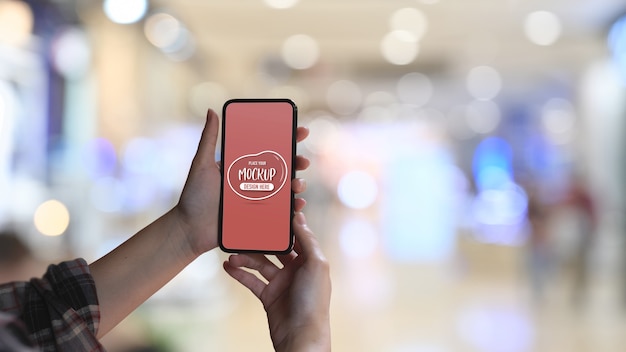 Close up view of female hand holding mock up smartphone