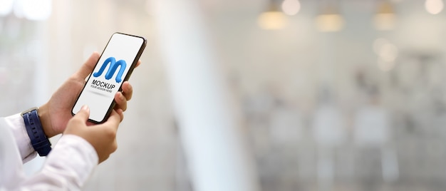 PSD close up view of female hands holding mock up smartphone