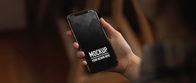 Close up view of female hands holding mockup smartphone