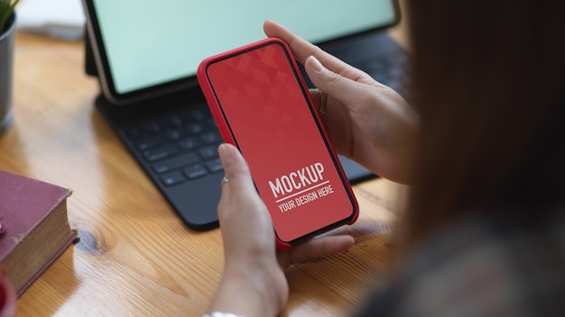 Close up view of female hands holding smartphone mockup