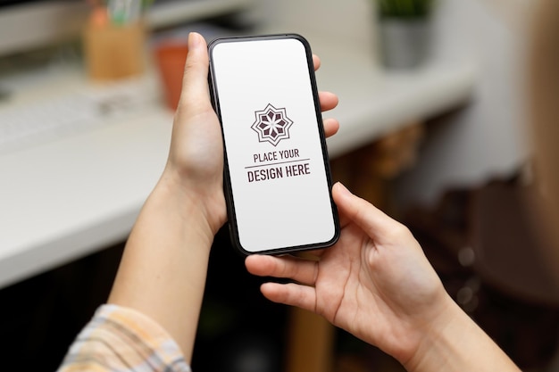 Close up view of female hands holding smartphone mockup