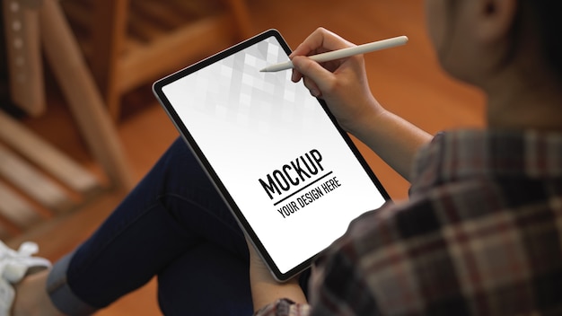 Close up view of female worker using digital tablet mockup with stylus pen