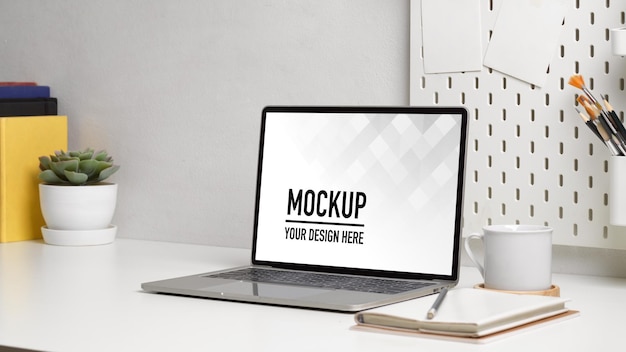 Close up view of home office desk with laptop mockup