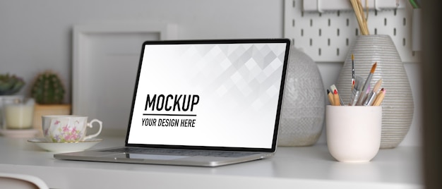 Close up view of laptop mockup, stationery and decorations