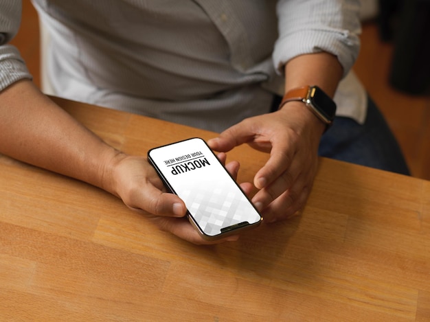 PSD close up view of male hands using smartphone mockup