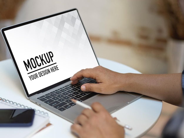 Close up view of male hands working with laptop mockup