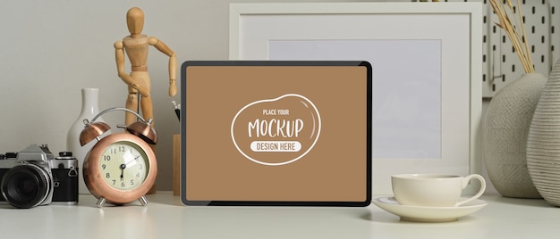 Close-up view of modern office room with mock up tablet, coffee cup and office supplies