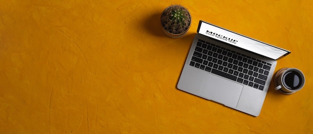 Close up view of workspace with laptop mockup in home office