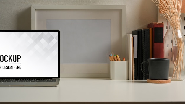 PSD close up view of workspace with laptop mockup in home office