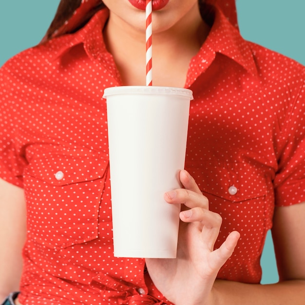 Close up woman drinking with straw