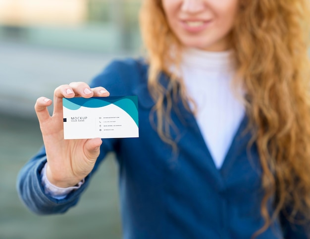 PSD close up woman holding business card