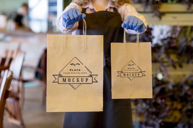 Close-up woman holding paper bags