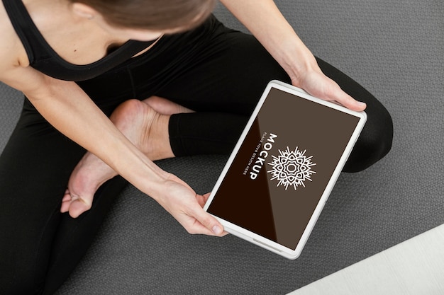 Close up woman holding tablet yoga branding