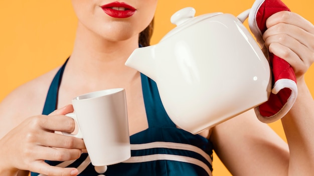 close up woman holding tea pot