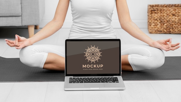 close up woman meditating with laptop