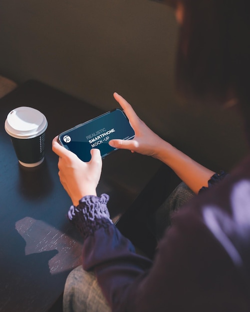 PSD close up of woman using smartphone in cafe