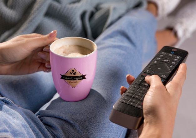 PSD close-up woman with mug and remote