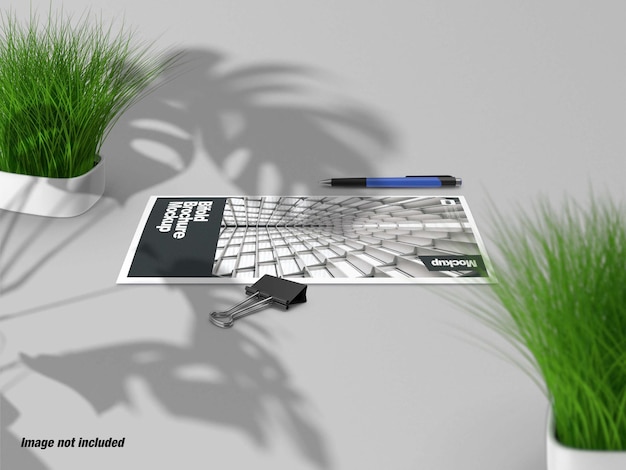 Closed bifold brochure with plant on table 3d mockup