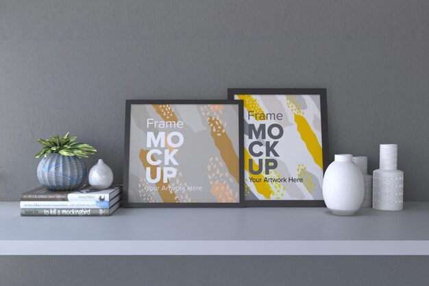 Closeup of a black frame with vases and books on a gray wall background frame mockup