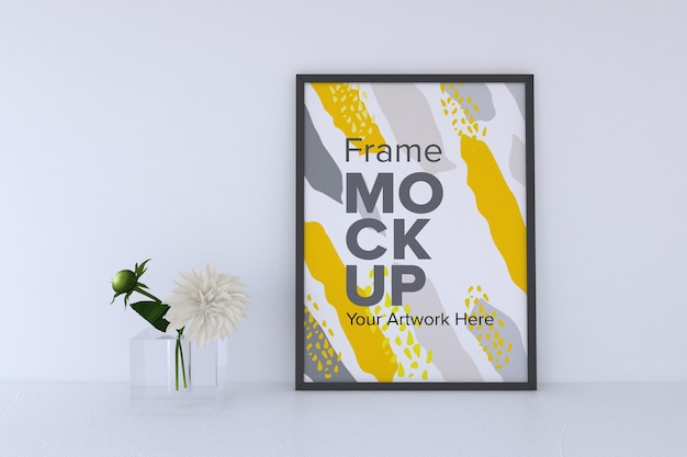 Closeup of a decorative plant next to a white frame on a gray wall background frame mockup