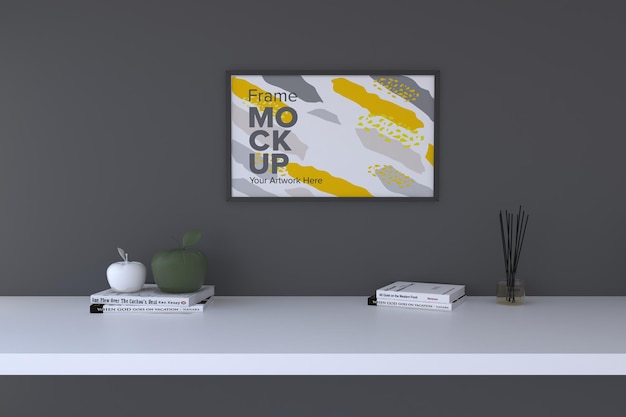 Closeup of a decorative plant next to a white frame on a gray wall background frame mockup
