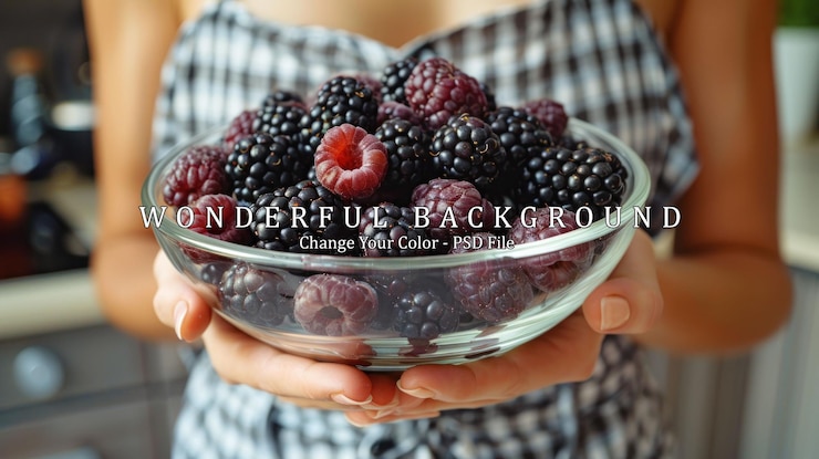 PSD closeup of hands holding a bowl of blackberries and raspberries
