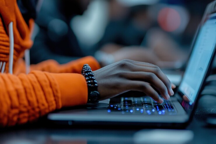 PSD closeup of hands typing on laptop keyboard