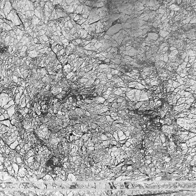 Closeup of a fractured and eroded rock surface showing intricate textures